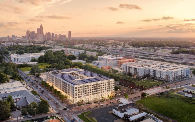 a city with a large building and a large parking lot