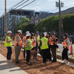 construction workers standing on a section of dirt