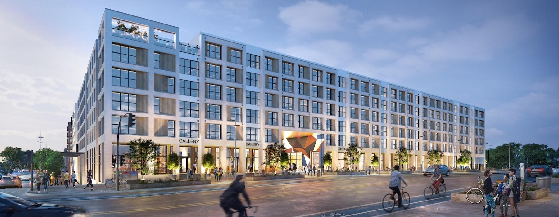 a large building with people riding bikes