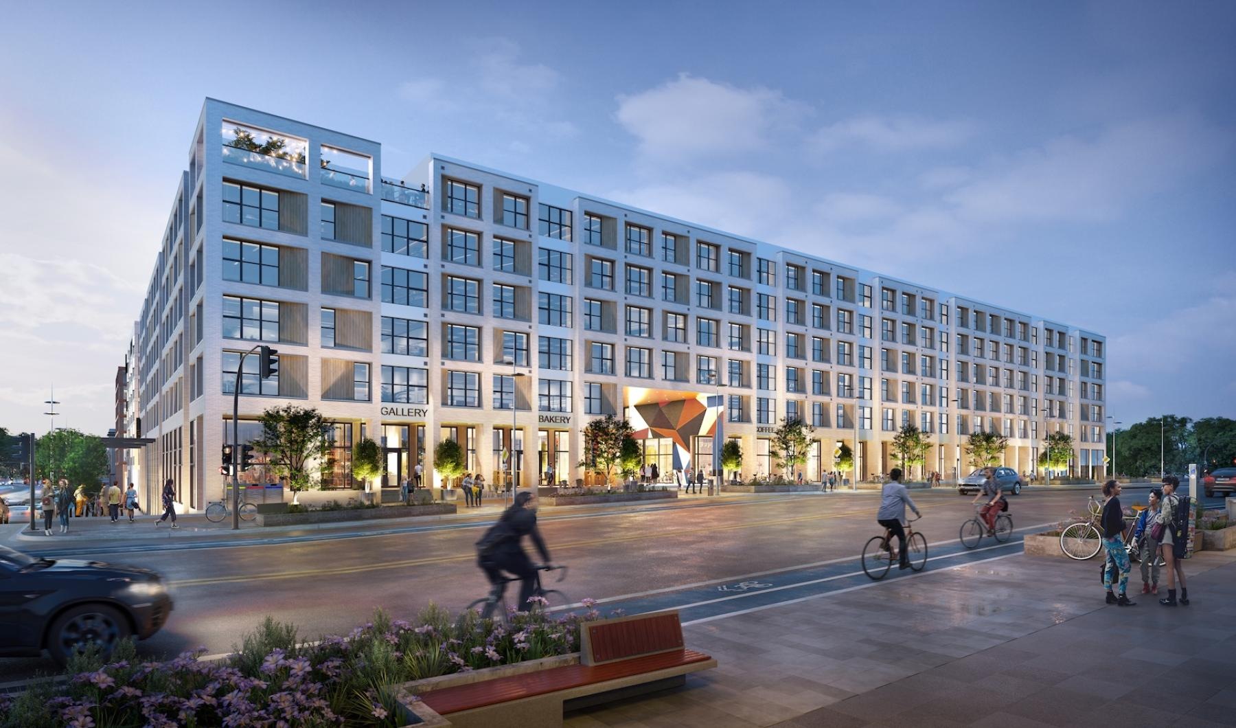 a large building with people riding bikes